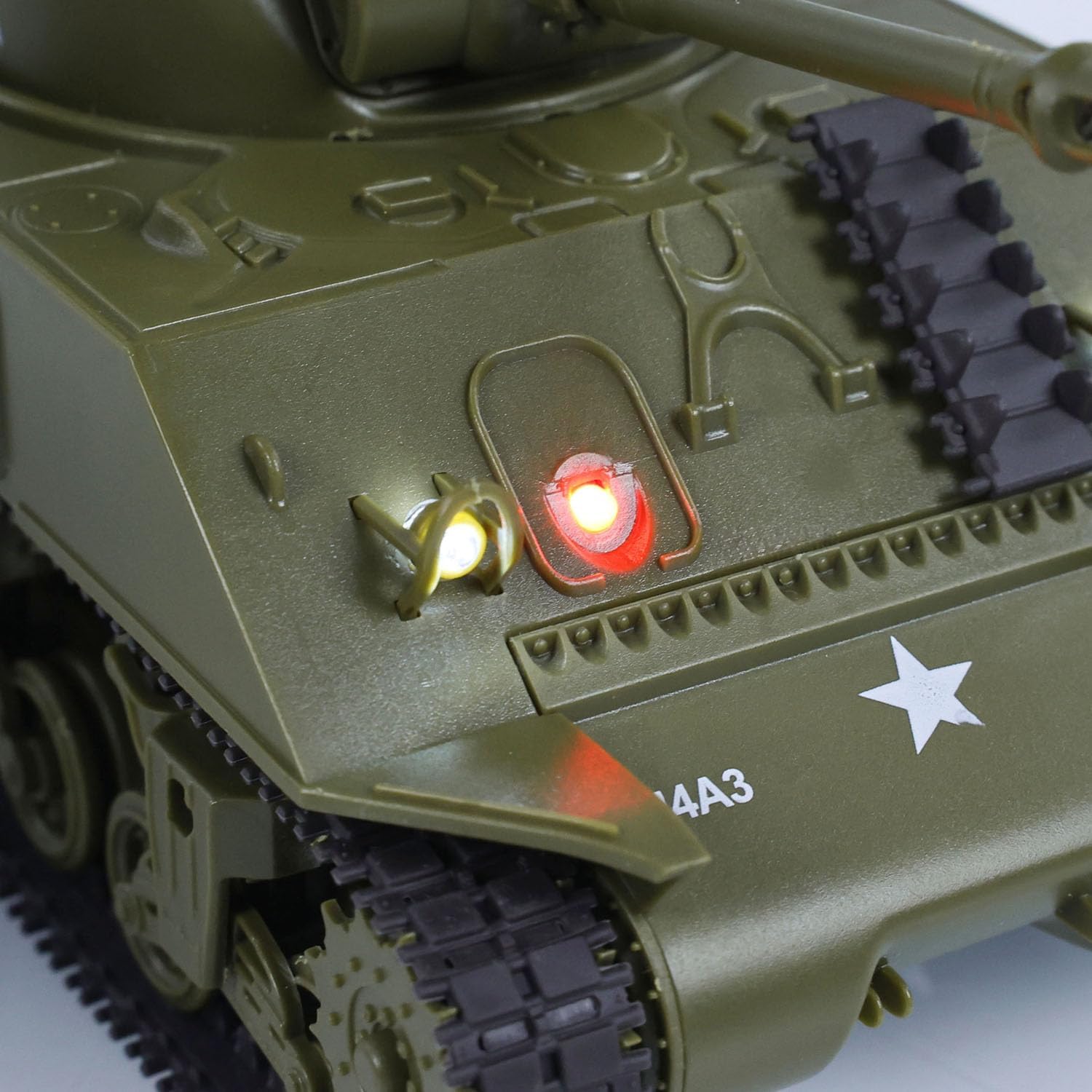 Close-up of a toy tank with illuminated lights on a white background